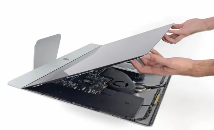 Technicien retirant l'écran d'un iMac